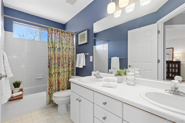 bathroom with double vanity, a sink, toilet, and shower / bath combo with shower curtain