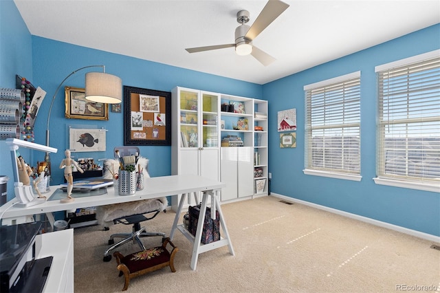 carpeted home office featuring ceiling fan, visible vents, and baseboards