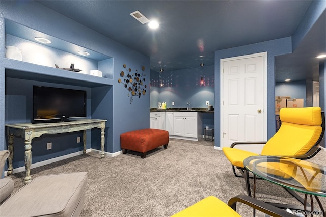 living area with baseboards, carpet floors, visible vents, and wet bar