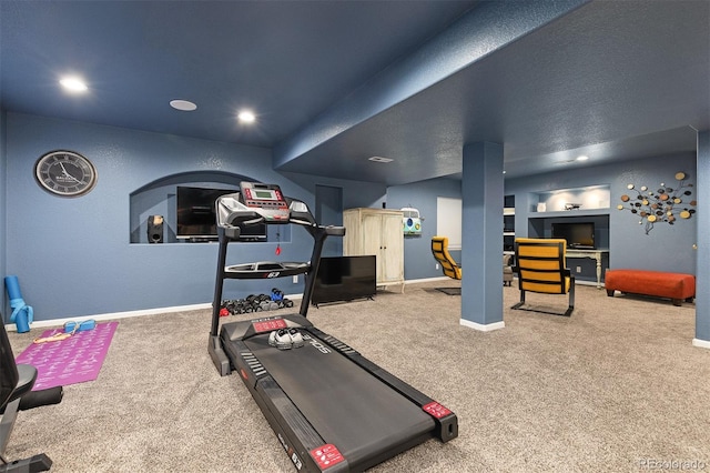 exercise area featuring baseboards, carpet flooring, and recessed lighting