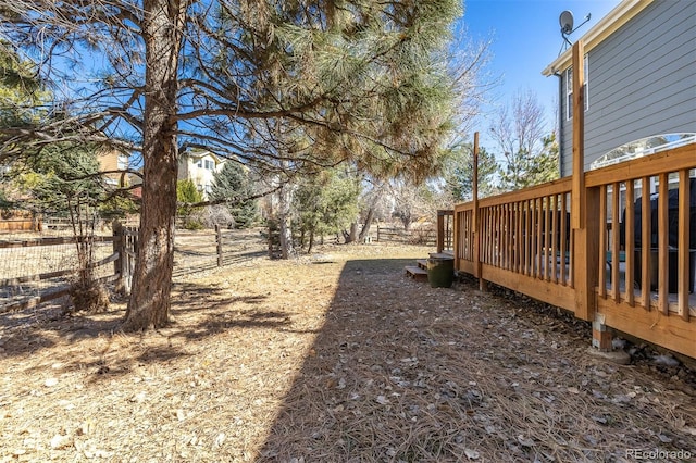 view of yard with a wooden deck and fence