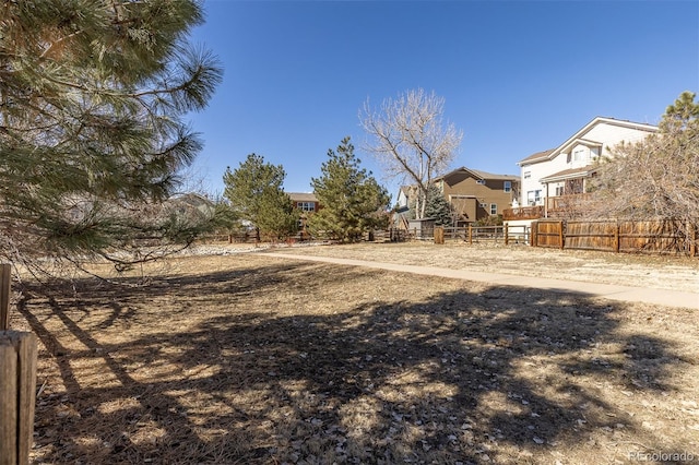 view of yard featuring a residential view and fence