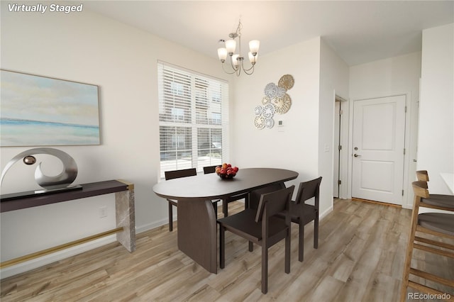 8376 Lorenzo Ln Unit A, Highlands Ranch, CO 80129 - dining room featuring a chandelier and light wood finished floors