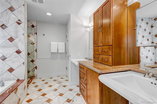bathroom with visible vents, a wainscoted wall, a tile shower, and a relaxing tiled tub