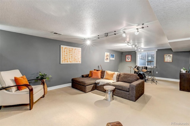 living room with baseboards, carpet flooring, a textured ceiling, and rail lighting