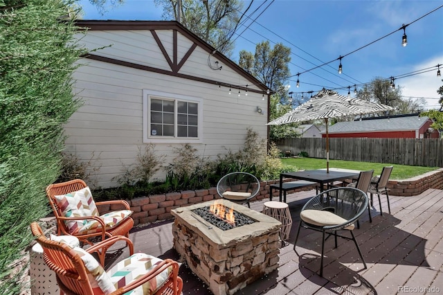 view of patio / terrace featuring outdoor dining area, a fenced backyard, and an outdoor fire pit