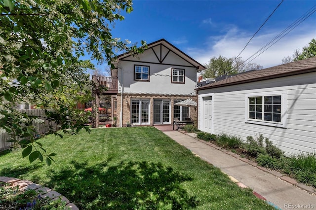 back of house with a lawn, fence, a balcony, and a patio area