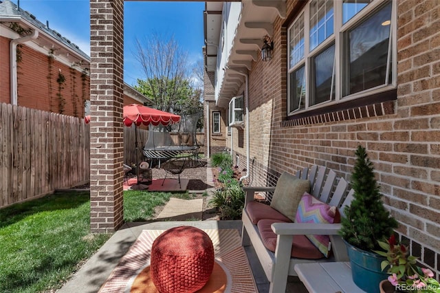 view of patio featuring fence