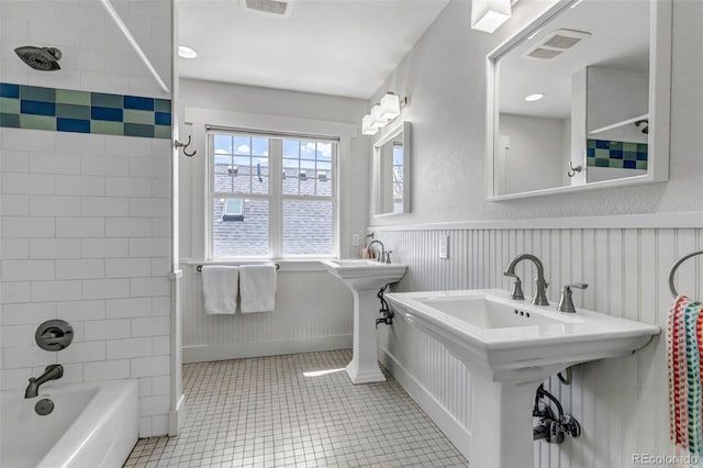 full bathroom with shower / bath combination, visible vents, wainscoting, and tile patterned floors