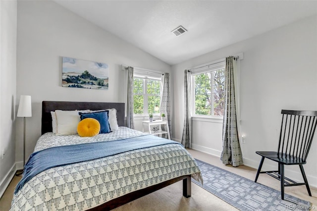bedroom with baseboards, vaulted ceiling, carpet flooring, and visible vents