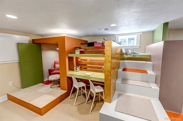 interior space featuring recessed lighting, a textured ceiling, and visible vents