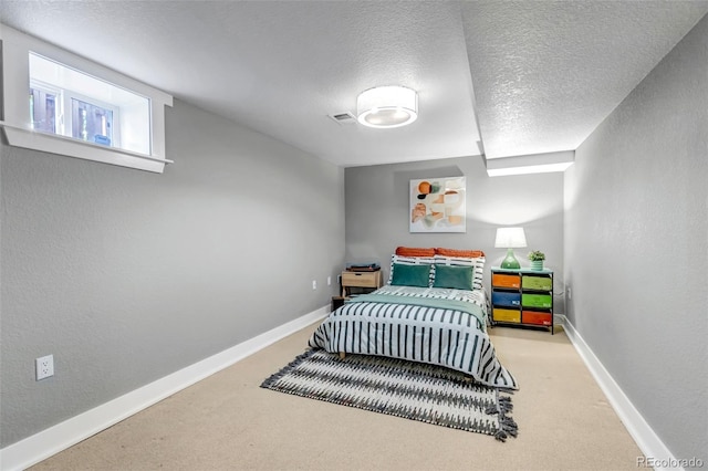 carpeted bedroom featuring visible vents, a textured ceiling, and baseboards