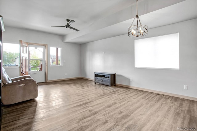 32 Trailside Cir Unit A, Salida, CO 81201 - unfurnished living room featuring wood finished floors, a chandelier, baseboards, and ceiling fan