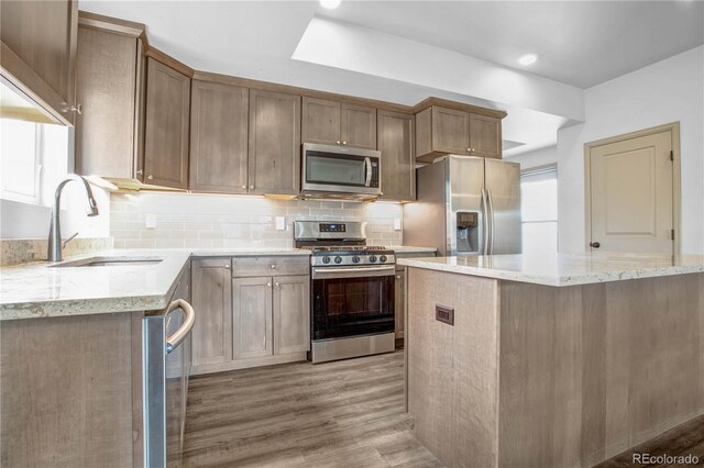 32 Trailside Cir Unit A, Salida, CO 81201 - kitchen featuring stainless steel appliances, a sink, light stone counters, light wood finished floors, and recessed lighting