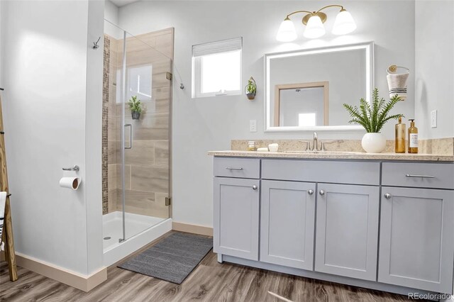 32 Trailside Cir Unit A, Salida, CO 81201 - bathroom featuring a stall shower, wood finished floors, vanity, and baseboards