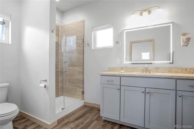 32 Trailside Cir Unit A, Salida, CO 81201 - full bathroom featuring toilet, wood finished floors, a stall shower, vanity, and baseboards