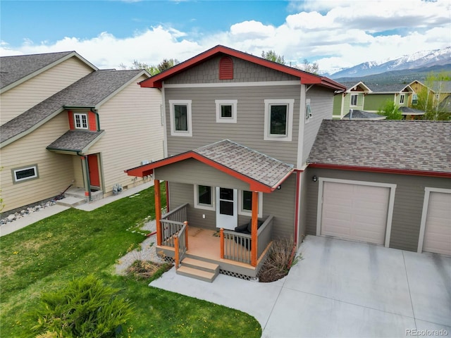 32 Trailside Cir Unit A, Salida, CO 81201 - back of property featuring a garage, concrete driveway, a lawn, and a deck with mountain view