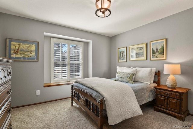 bedroom with carpet floors and baseboards