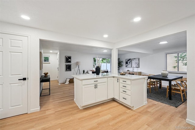 11176 W 62nd Ave, Arvada, CO 80004 - kitchen featuring open floor plan, light wood-style floors, white cabinetry, light countertops, and recessed lighting
