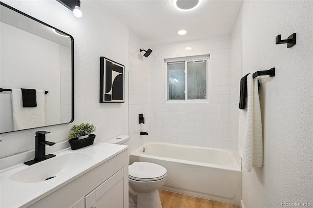 11176 W 62nd Ave, Arvada, CO 80004 - bathroom with wood finished floors, vanity, a textured wall, and shower / washtub combination