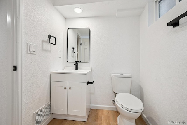 11176 W 62nd Ave, Arvada, CO 80004 - bathroom with vanity, wood finished floors, and a textured wall