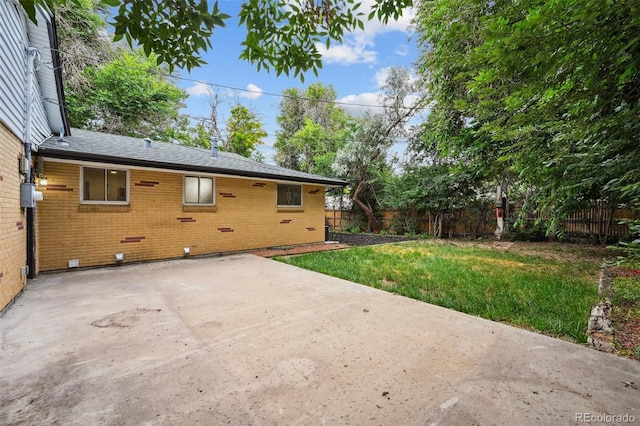 11176 W 62nd Ave, Arvada, CO 80004 - rear view of house with a patio area, a fenced backyard, brick siding, and a shingled roof