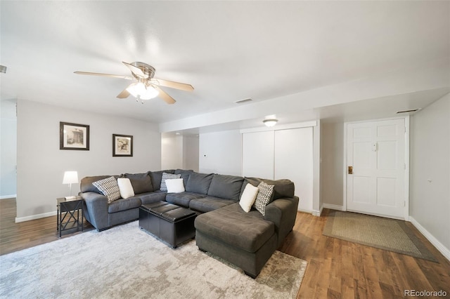 living room with ceiling fan and hardwood / wood-style floors