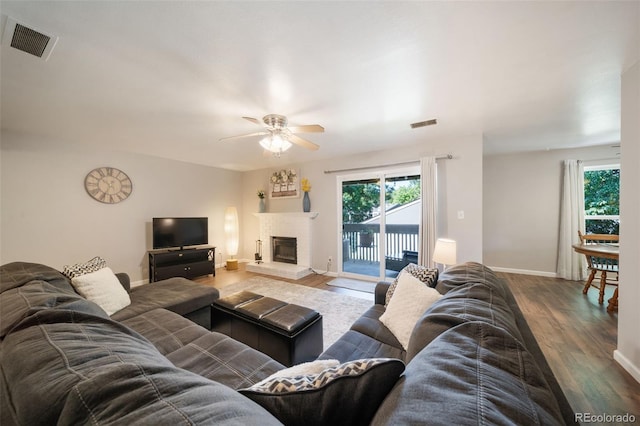 living room with ceiling fan and wood-type flooring