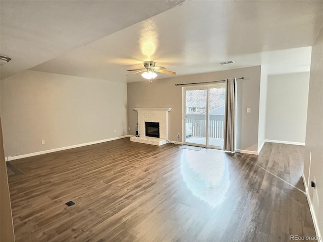 unfurnished living room featuring dark hardwood / wood-style floors, ceiling fan, and a fireplace