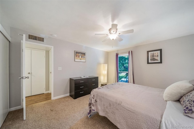 carpeted bedroom featuring ceiling fan and a closet