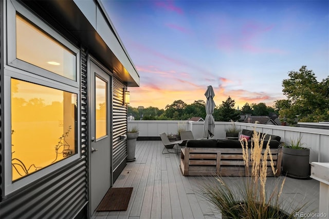 deck at dusk featuring outdoor lounge area