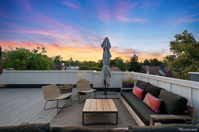 deck at dusk featuring an outdoor living space