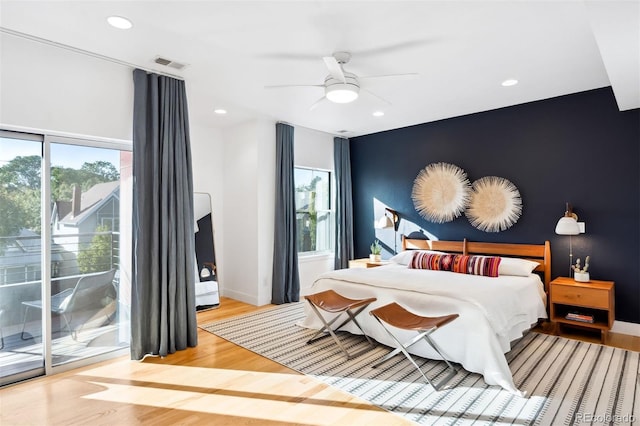 bedroom with access to exterior, wood-type flooring, and ceiling fan