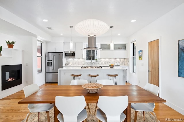 dining space featuring light hardwood / wood-style floors