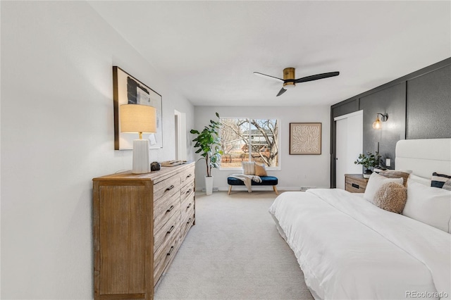 bedroom with ceiling fan and light colored carpet