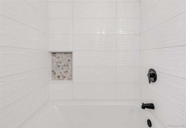 interior details featuring tiled shower / bath