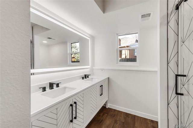 bathroom with vanity and hardwood / wood-style flooring