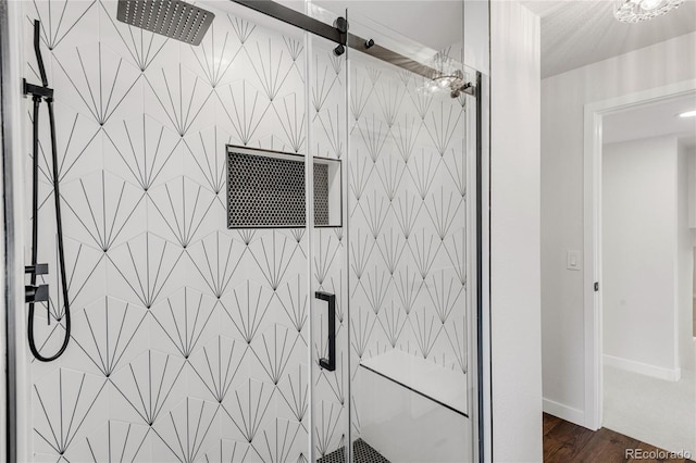 bathroom with wood-type flooring and an enclosed shower