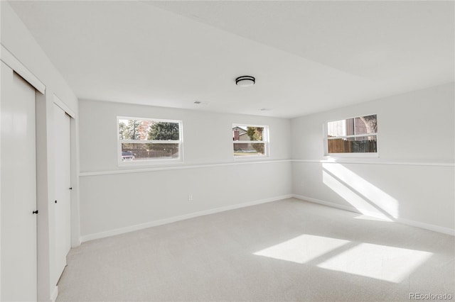 unfurnished bedroom with light carpet and a closet