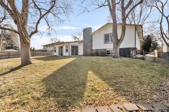 rear view of house with a yard