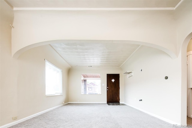 interior space featuring light carpet and baseboards