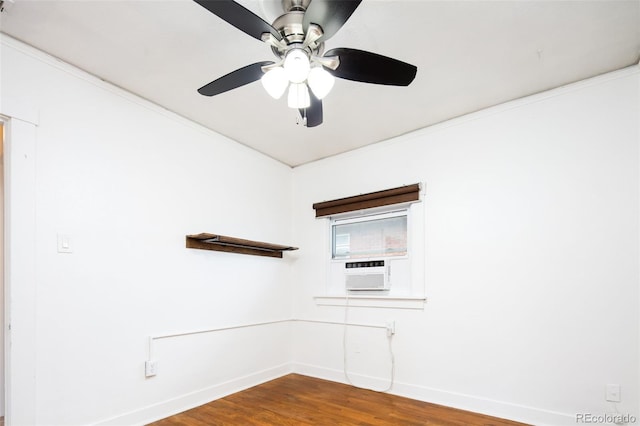 spare room featuring wood finished floors, a ceiling fan, and baseboards