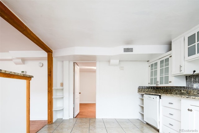 kitchen featuring light tile patterned flooring, white dishwasher, visible vents, and white cabinetry