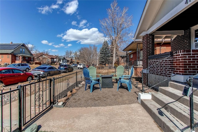 view of patio / terrace with fence and a residential view