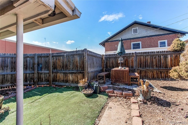 view of yard with a fenced backyard