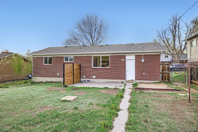 1207 Kingsley Dr, Colorado Springs, CO 80909 - rear view of house with a patio area, brick siding, and a gate