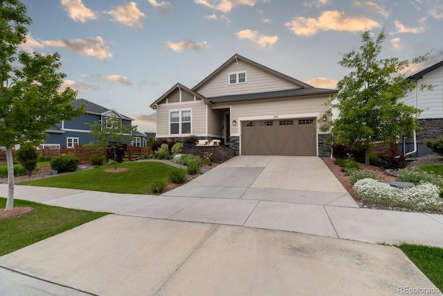 565 Pikes View Dr, Erie, CO 80516 - craftsman house featuring an attached garage, driveway, a lawn, and stone siding