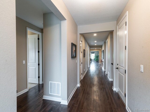 565 Pikes View Dr, Erie, CO 80516 - hallway with dark wood-style flooring and baseboards