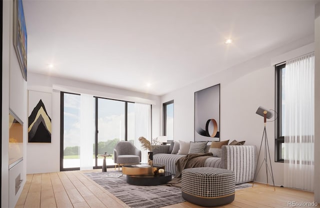 living area featuring light wood-style flooring, healthy amount of natural light, and recessed lighting