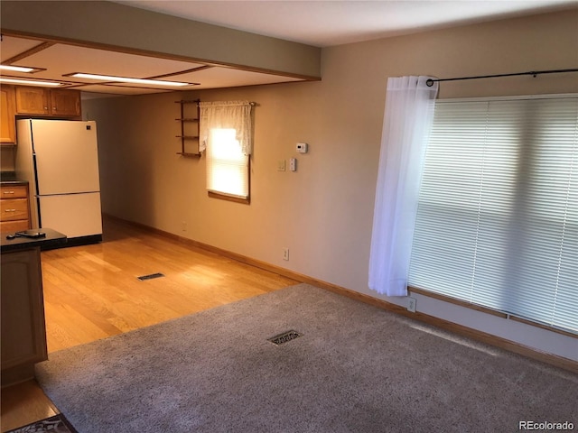 kitchen featuring light hardwood / wood-style flooring and white refrigerator